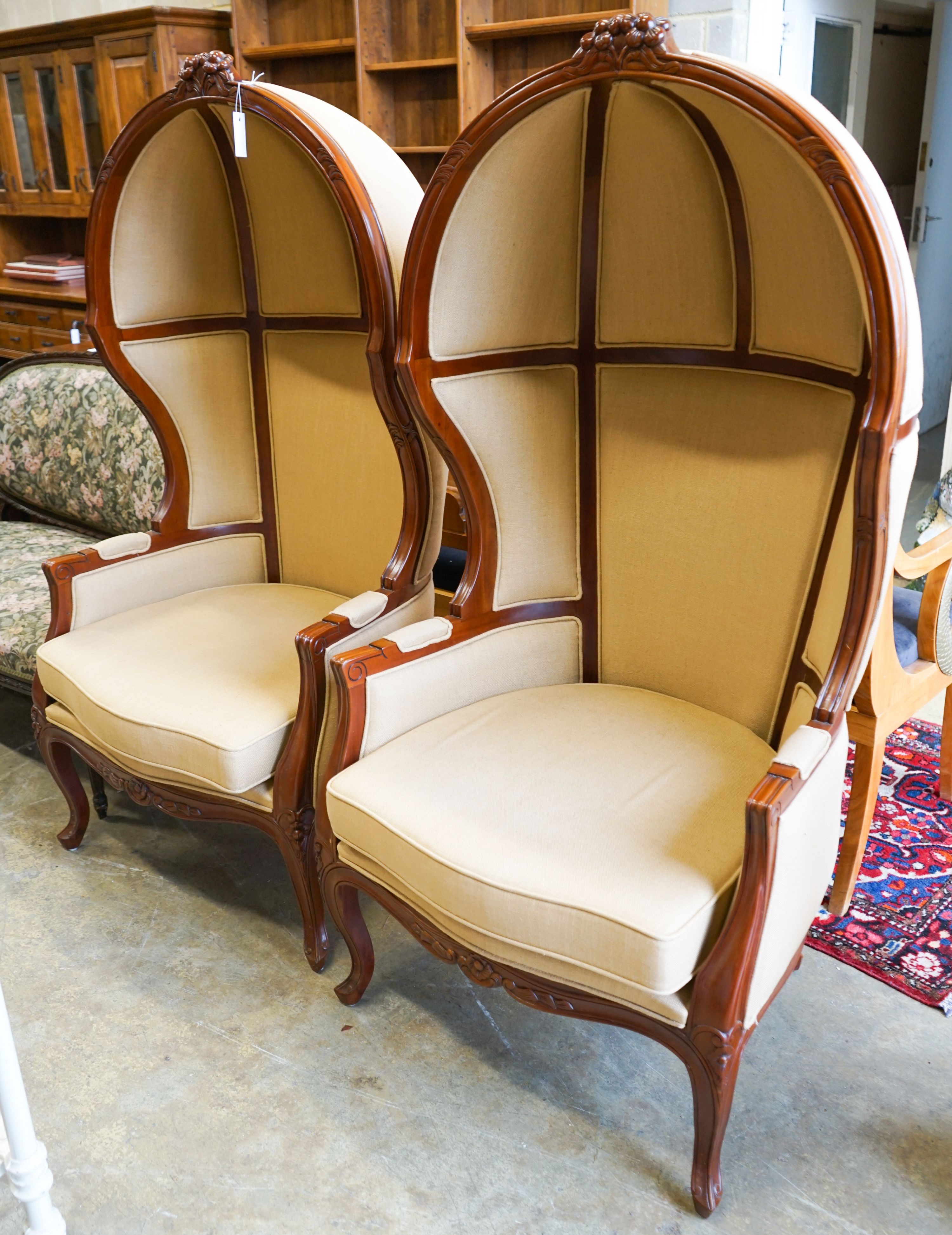 A pair of Victorian style upholstered carved mahogany hall porter's chairs, width 80cm, depth 66cm, height 162cm